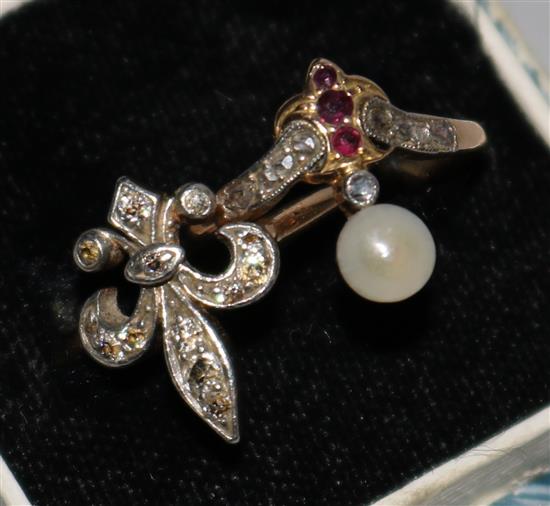 A diamond set  Fleur de Lys ring and one other gem set ring.